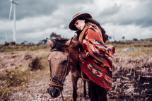 a woman hugging a horse 