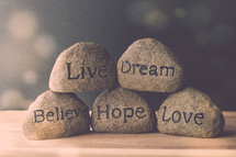 stones with the words live, believe, hope, love, and dream