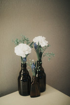 flowers in a brown bottle vases
