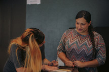 a woman filling out an information card at church 