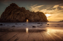 sea cave in rock formation at sunrise 