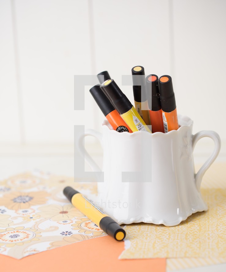 orange and yellow paint pens 