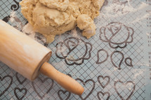 a rolling pin and cookie dough 