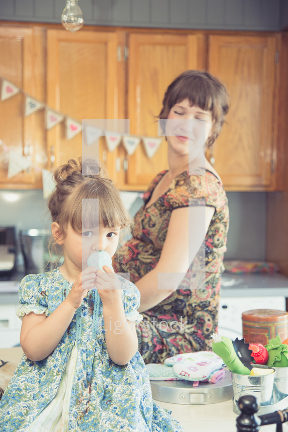 mother and daughter together in a kitchen 