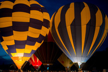 Hot air balloons lit up at a festival.