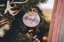 Wooden ornament with the word "almighty" on a Christmas tree 