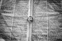 wedding rings on the pages of a Bible 