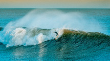 surfer braving large waves 