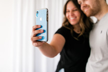 couple taking a selfie or video chatting 