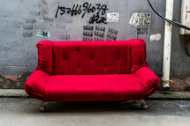 red couch on a street in China 