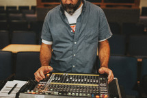 man at a soundboard