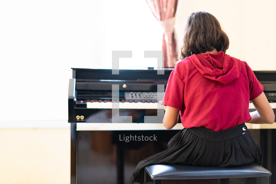 a girl playing a piano 