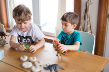 kids playing with toy dinosaurs 