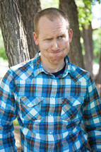 man in a plaid shirt making a silly face 
