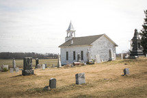 old rural church surrounded by a cemetery 