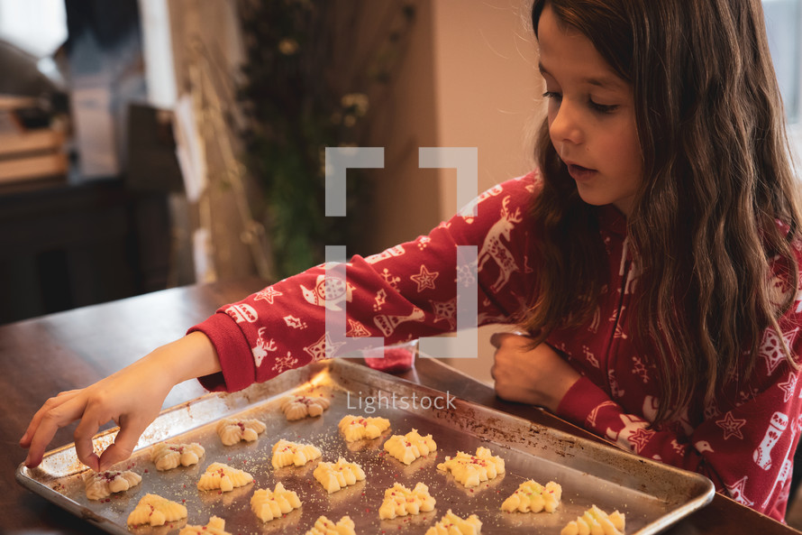 Little girl decorating Christmas cookies