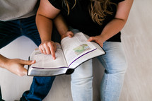 a couple reading a Bible together 