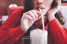 a woman drinking a milkshake 