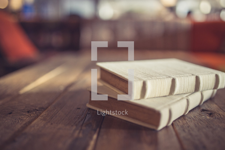 books on a wood coffee table 