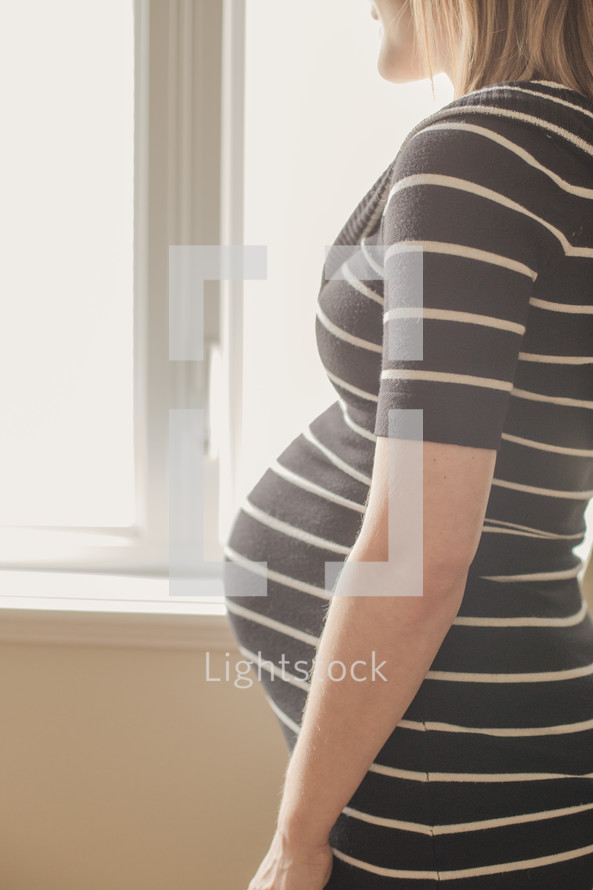 side profile of a pregnant woman's belly
