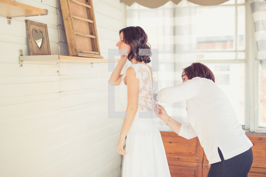seamstress altering a wedding dress 