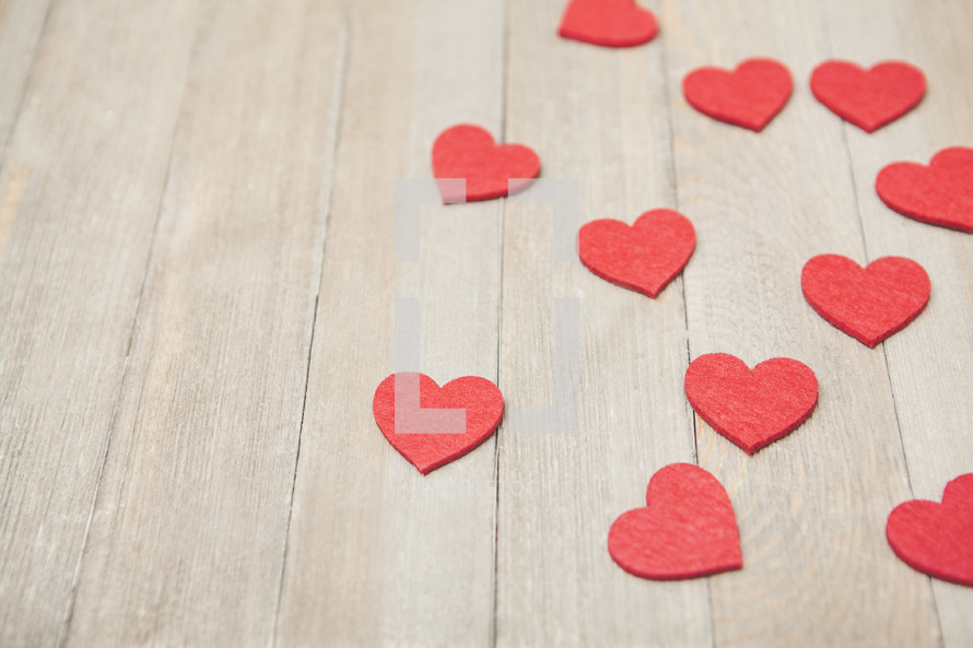 red hearts on a wood background 
