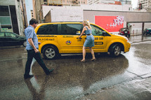 A couple catching a taxi. 