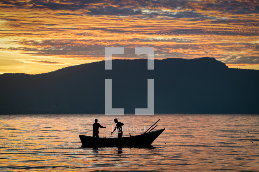 fishermen fishing at sunset 