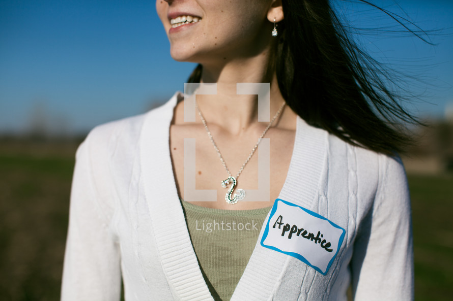 woman wearing an apprentice name tag