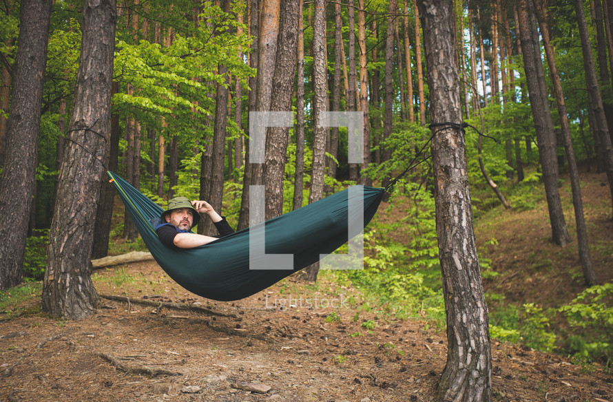 a man resting in a hammock 