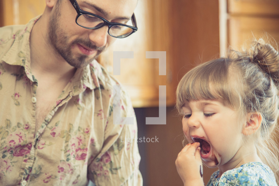 father and daughter together in a kitchen 