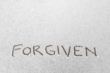 word forgiven written in snow 