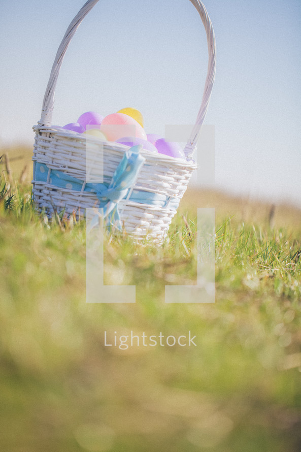 Easter basket full of eggs in the grass