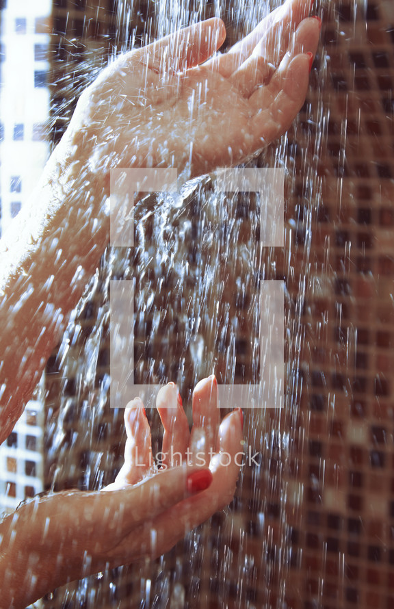 a woman's hands in the shower 