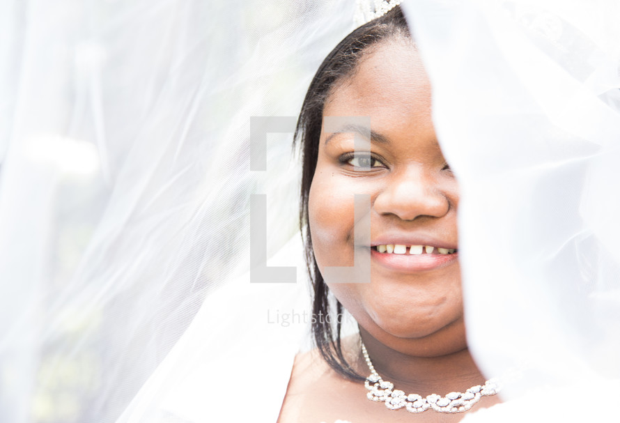 face of an African American bride under her veil 