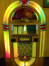 A colorful Music Jukebox from the vintage 1950s to play CD's or Music Tracks at the push of a button. There are some things that are icons from yesterday and yesteryear that should never be forgotten. The Jukebox will definitely be one of those icons that will never be forgotten and can still be found in some local restaurants today to capture that special time in history when a young man or woman could put a quarter in a Jukebox to select a favorite song to listen or dance to together. 
