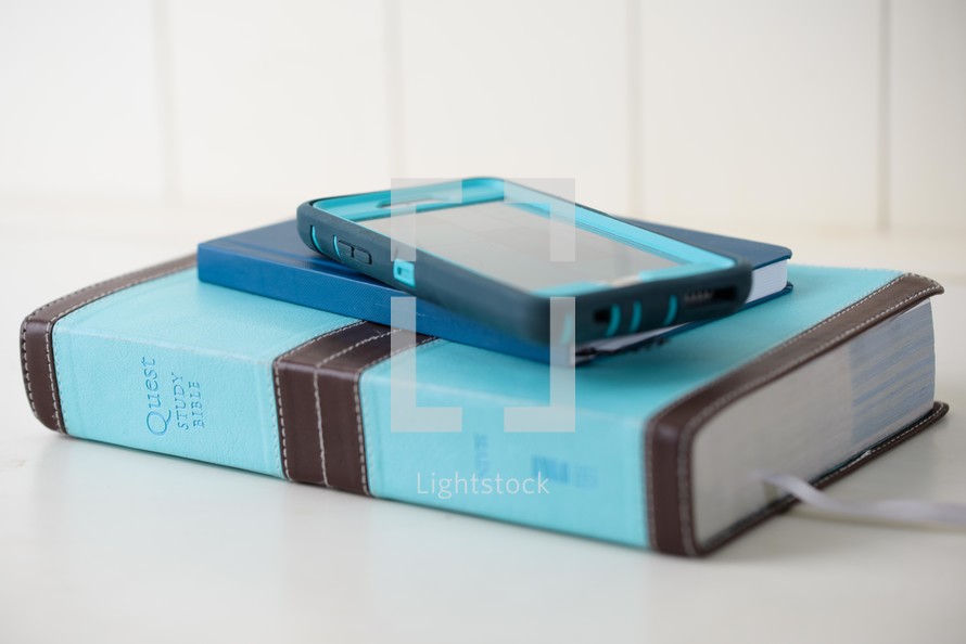 teal Bible, journal, and cellphone 