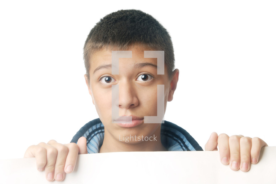 Studio photo of the boy holding a white paper board