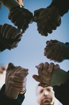 group holding hands in prayer