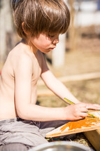 a child painting wood 