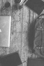 Laptop, bag, notebooks, Bible and coffee on a table
