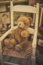 A teddy bear sitting in a rocking chair