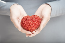 a woman holding a red heart 