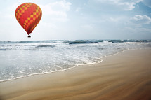 hot air balloon over a beach 