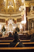 people sitting in pews of a church at Christmas 