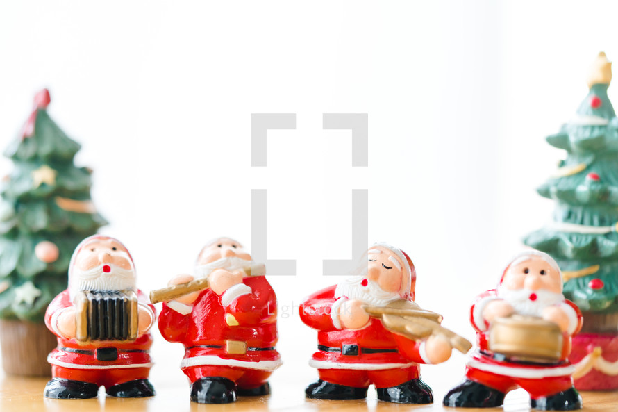 Santa Claus figurines against a white background 