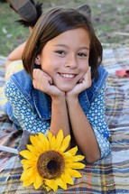 smiling girl child portrait with sunflower 