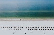 view of lounge chairs in rows on a beach 