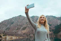 woman talking a selfie outdoors 