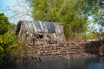 straw hut along a river 